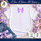 White shirt back with lavender bow and Eleanor letters stacked vertically down the middle