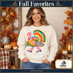 Colorful Turkey Pink Boots Thanksgiving design. Woman wearing the design on a Natural crewneck sweatshirt. The Big Man Designs.