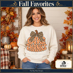 Give Thanks Leopard Bow Thanksgiving design. Woman wearing the design on a Natural crewneck sweatshirt. The Big Man Designs.