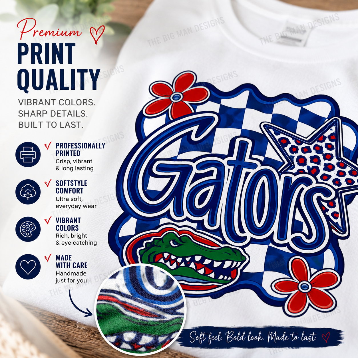 A white crewneck sweatshirt featuring a large Gators graphic print with blue, red, and white colors. The graphic includes the word 'Gators' in bold blue letters, a red alligator head, a red flower, and a blue-and-white checkered border.
