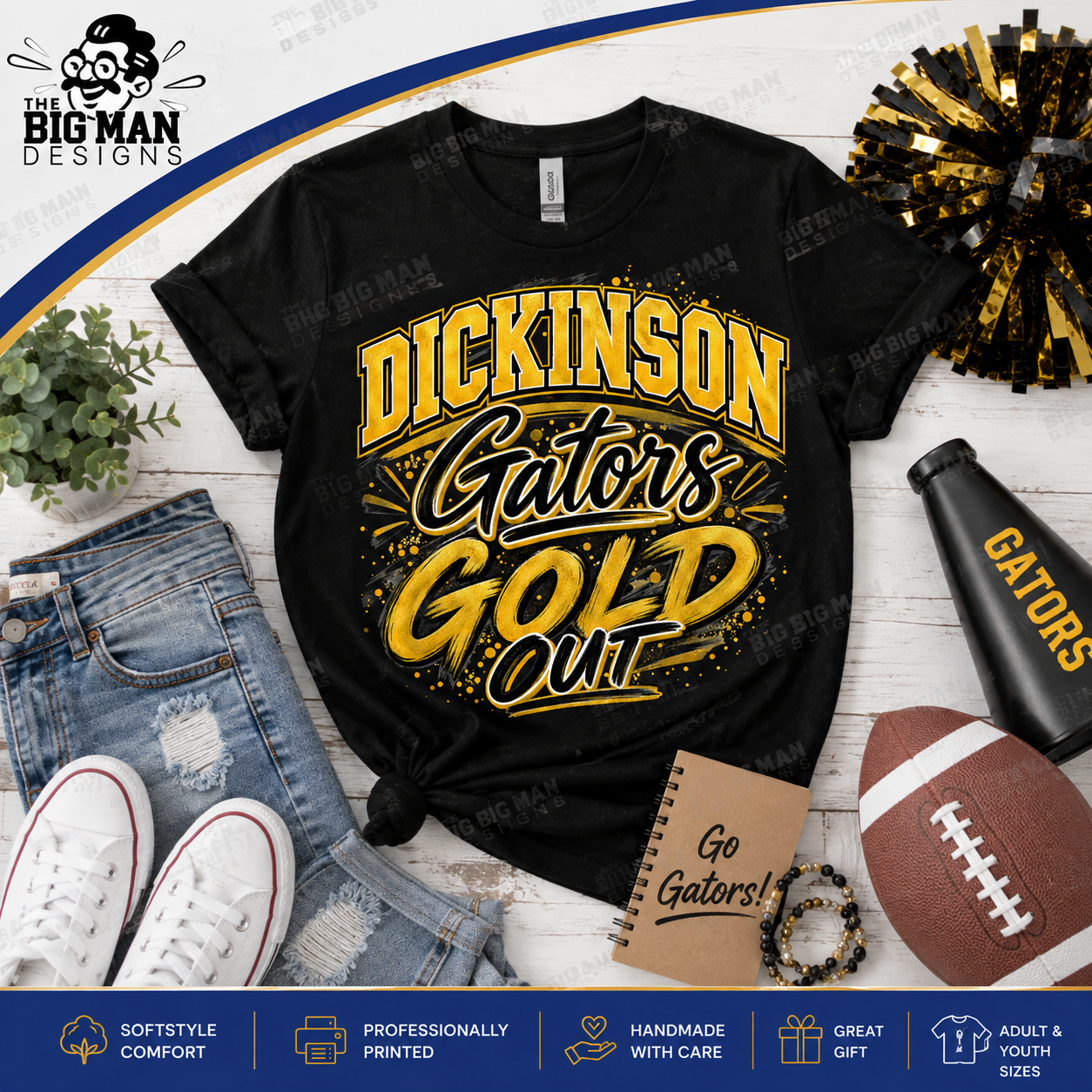 A black graphic T-shirt laid flat on a white wood background with styled props including jeans, white sneakers, a football, a pom-pom, a notebook, and a black megaphone. The shirt reads 'DICKINSON Gators GOLD OUT' in large yellow and black lettering.