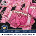 A close-up of a DTF printed fabric design featuring pink footballs and breast cancer awareness ribbons on a black and pink striped background, with branding for The Big Man Designs and feature badges.