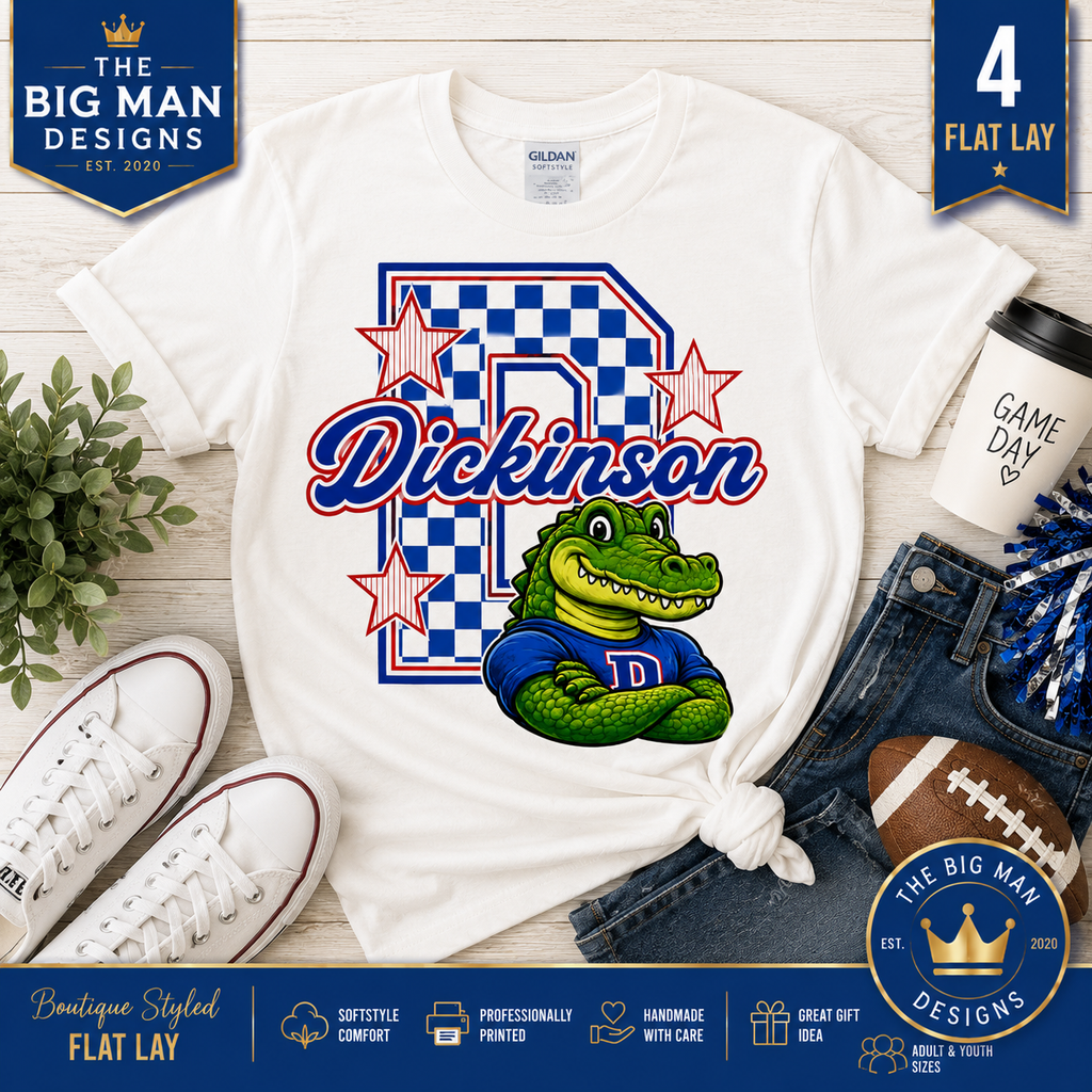 A white Gildan t-shirt shown in a flat lay with jeans, sneakers, a football, a coffee cup, and decorative text overlays. The shirt features a graphic with a blue checkerboard 'D', the name 'Dickinson' in red script, and a green alligator wearing a blue 'D' jersey.