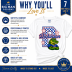 A white graphic T-shirt displayed on a white background with promotional text and icons. The shirt features a large blue and white checkered square, red stars, the name 'Dickinson' in blue script, and a green alligator wearing a blue 'D' logo.
