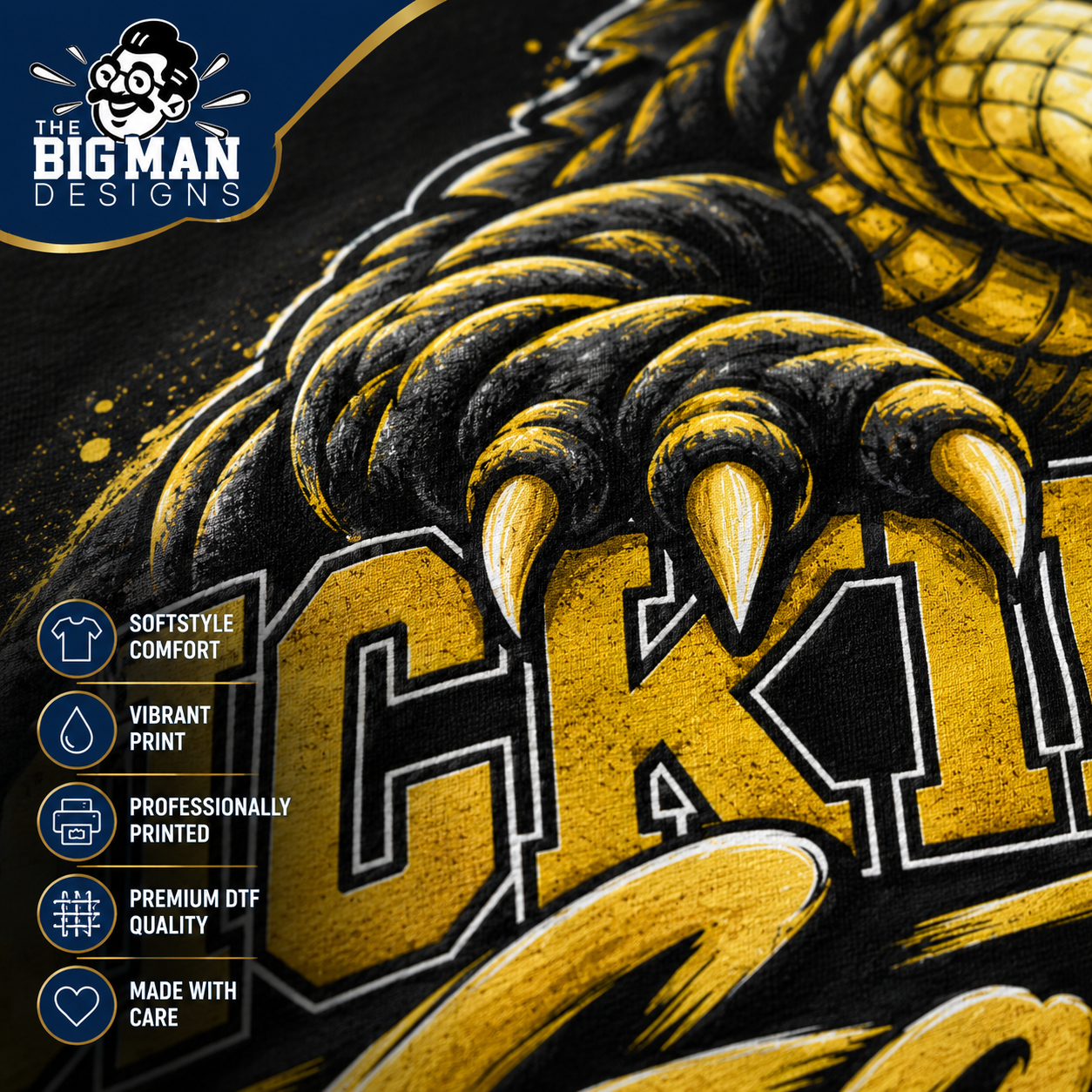 Close-up of a graphic print featuring a large yellow and black monster claw over bold lettering, with a blue and black 'The Big Man Designs' logo in the top left and feature callouts along the left side.