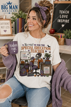 A woman wearing a white graphic t-shirt with a Halloween-themed special education teacher design, holding a purple mug. The t-shirt features a cartoon skeleton teacher at a desk with books and a chalkboard.