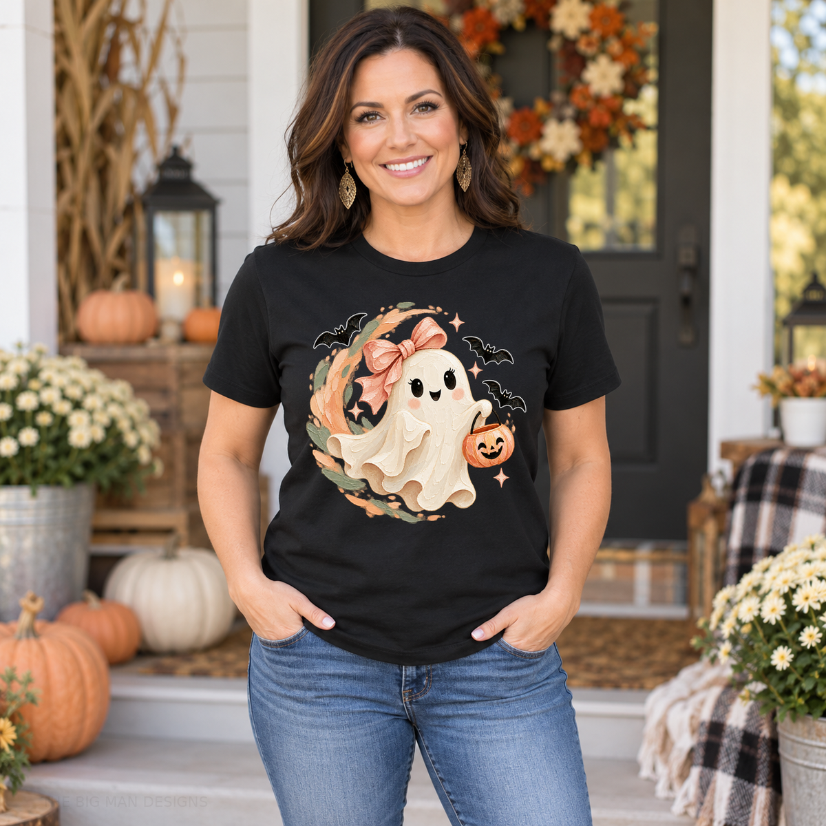 Woman wearing a black ghost and pink bow Halloween tee on an autumn porch.