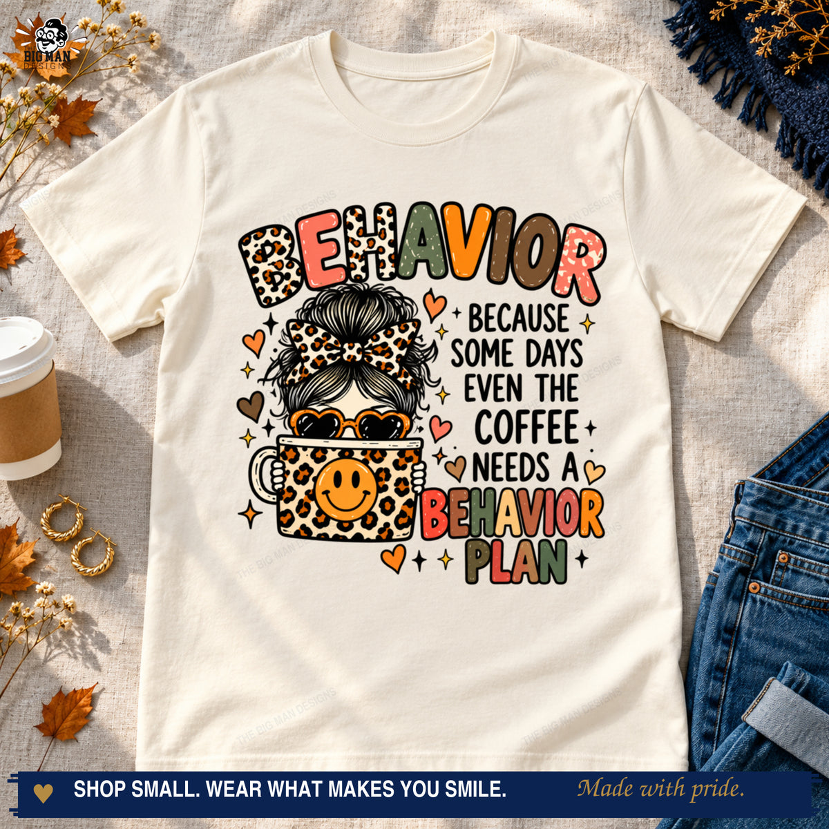 Natural teacher humor T-shirt with messy bun, leopard coffee cup, and behavior plan wording styled with jeans and coffee.