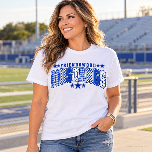 Customer wearing a white Friendswood Mustangs patchwork varsity school spirit T-shirt.