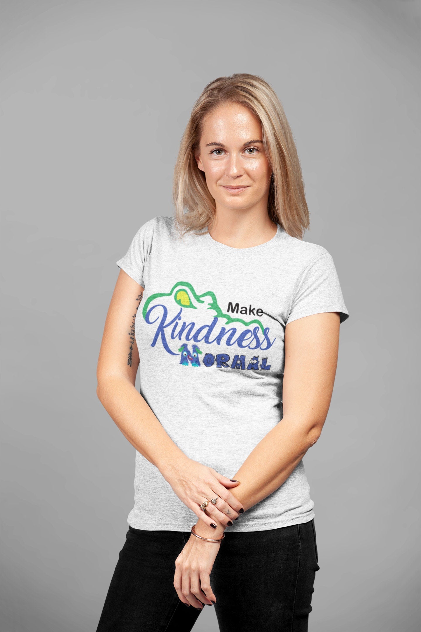Model wearing the Dickinson Gators kindness shirt in heather gray, styled for casual wear