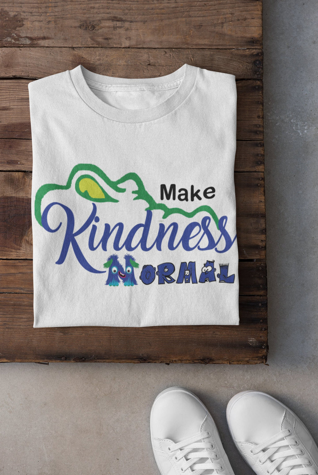 Flat-lay of the kindness-themed t-shirt paired with jeans and sneakers for a trendy school spirit look.