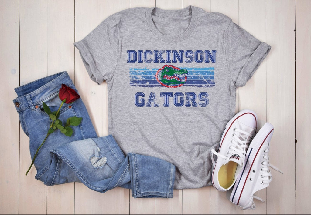 Flat lay of Dickinson Gators grey t-shirt with jeans and sneakers