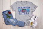 Flat lay of Dickinson Gators grey t-shirt with jeans and sneakers