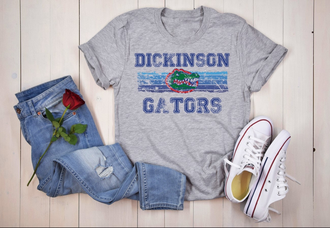 Flat lay of Dickinson Gators grey t-shirt with jeans and sneakers