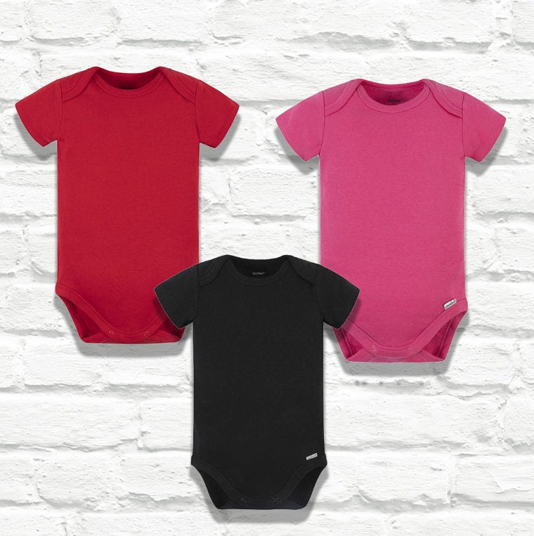 Red onesie, hot pink onesie, and black onesie