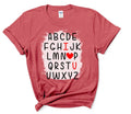 ABCD I Love You V-Day Tee – Quirky Valentines Shirt | Love Letter Tee - DTF Printed Cotton.  Say it with a twist this Valentine’s Day! This V-Day Tee delivers a quirky take on romance with playful typography & a modern design that reads like the alphabet. Printed using advanced DTF technology, this tee is available in two premium fabric options: a classic 100% cotton version and a standout heather red variant made from a 65/35 polyester/cotton blend with a bleached center to make the design pop.