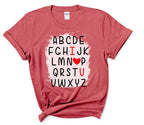 ABCD I Love You V-Day Tee – Quirky Valentines Shirt | Love Letter Tee - DTF Printed Cotton.  Say it with a twist this Valentine’s Day! This V-Day Tee delivers a quirky take on romance with playful typography & a modern design that reads like the alphabet. Printed using advanced DTF technology, this tee is available in two premium fabric options: a classic 100% cotton version and a standout heather red variant made from a 65/35 polyester/cotton blend with a bleached center to make the design pop.