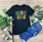 Mardi Gras Faux Glitter Teacher T-Shirt | DTF Printed 
Get ready to let the good times roll with this festive Mardi Gras teacher t-shirt! 🎉 Featuring a faux glitter design (no mess, just sparkle!) on a super soft Gildan Softstyle tee, this is the perfect shirt for parades, classroom celebrations, or everyday fun.
