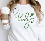 A Lucky Stethoscope Shirt designed for nurses, doctors, and medical professionals. This St. Patrick’s Day tee features the word "Lucky" creatively formed with a stethoscope in a high-quality DTF print. Made from 100% cotton, available in sport grey, natural, black, and white. A perfect medical-themed lucky shirt for nurse life, hospital workers, or a St. Paddy’s celebration. Soft, stylish, and durable—no cracking or peeling!