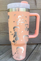 Pink large tumbler with handle laser engraved with hearts, the Betty Boop name and Betty Boop herself doing poses.