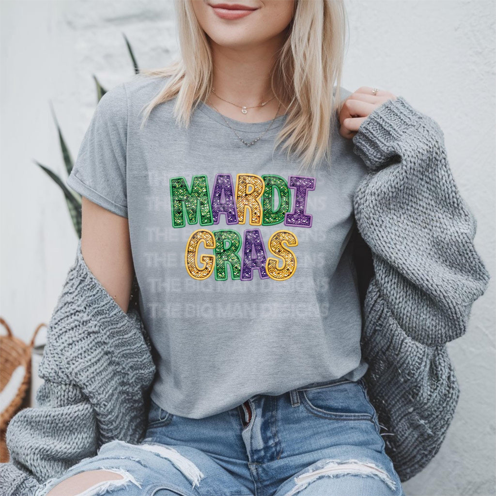 Mardi Gras Faux Glitter Teacher T-Shirt | DTF Printed 
Get ready to let the good times roll with this festive Mardi Gras teacher t-shirt! 🎉 Featuring a faux glitter design (no mess, just sparkle!) on a super soft Gildan Softstyle tee, this is the perfect shirt for parades, classroom celebrations, or everyday fun. Grey Gildan tshirt
