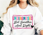 Get a laugh (and some knowing nods) with this "Undiagnosed But Something Ain’t Right" DTF transfer! Perfect for making funny, relatable t-shirts and hoodies, this bold and trendy design is ideal for anyone with a great sense of humor. No weeding, no hassle—just press and go! on white close up