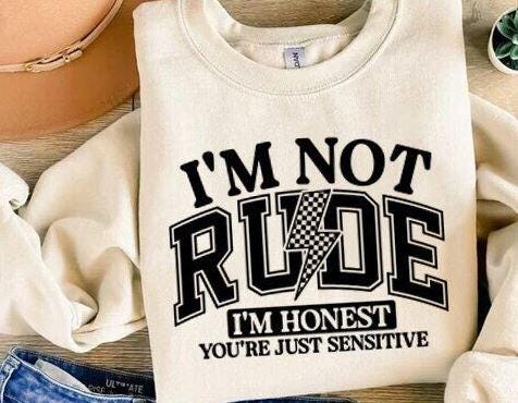 For the bold, the blunt, and the unapologetically honest—this "I'm Not Rude, I'm Honest – You're Just Sensitive" DTF transfer is perfect for those who speak their mind without sugarcoating it! Featuring a trendy, edgy design, this print is great for making a statement at work, with friends, or just in everyday life. close up