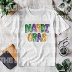 Mardi Gras Faux Glitter Teacher T-Shirt | DTF Printed 
Get ready to let the good times roll with this festive Mardi Gras teacher t-shirt! 🎉 Featuring a faux glitter design (no mess, just sparkle!) on a super soft Gildan Softstyle tee, this is the perfect shirt for parades, classroom celebrations, or everyday fun. White Gildan tshirt