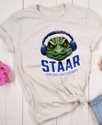 Get ready to rock testing season with our STAAR Rock Your Accommodations T-shirt! Featuring a bold gator head wearing oversized headphones, this shirt is perfect for teachers, administrators, and education staff who want to bring some fun and motivation to test prep. Closer version on natural