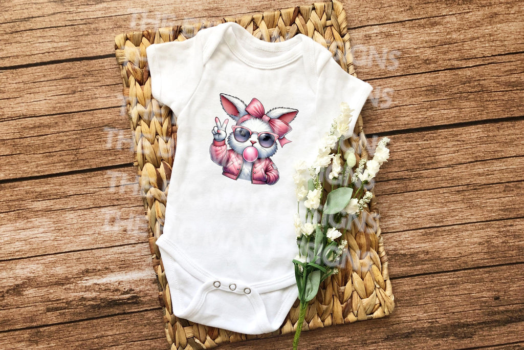 Hop into Easter with a vintage twist! This Retro Easter Bunny Blowing Bubble DTF Transfer features an adorable Easter Bunny in classic retro style, blowing a fun bubble for a playful, nostalgic feel. Perfect for anyone looking to add old-school charm to their Easter wardrobe, this transfer brings both style and fun to your holiday celebrations. On a onesie