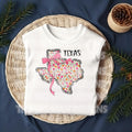 Show off your Texas pride with a feminine, coquette twist! This State Floral Coquette Texas DTF transfer features a beautifully hand-drawn Texas silhouette, adorned with delicate floral details and a soft, vintage-inspired aesthetic. Whether you're a proud Texan, a country girl at heart, or just love Southern charm, this design is perfect for rodeo season, boutique apparel, and everyday wear!