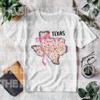Dress your little one in Texas charm with a coquette twist! This adorable State Floral Coquette Texas design features a hand-drawn Texas silhouette adorned with delicate florals for a soft, vintage-inspired Western aesthetic. Whether for rodeo season, Texas pride, or everyday Southern style, this onesie or toddler tee is a perfect choice! Toddler tshirt