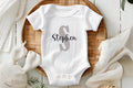Custom Name Baby Bodysuit | Personalized Baby Boy Outfit | Name Onesie® Toddler & Youth Tee

Make your little one’s outfit extra special with this personalized name onesie featuring a bold capital letter and a stylish script name underneath. This custom baby bodysuit is a thoughtful baby shower gift, newborn coming home outfit, or a unique keepsake for first birthdays and photo shoots.
