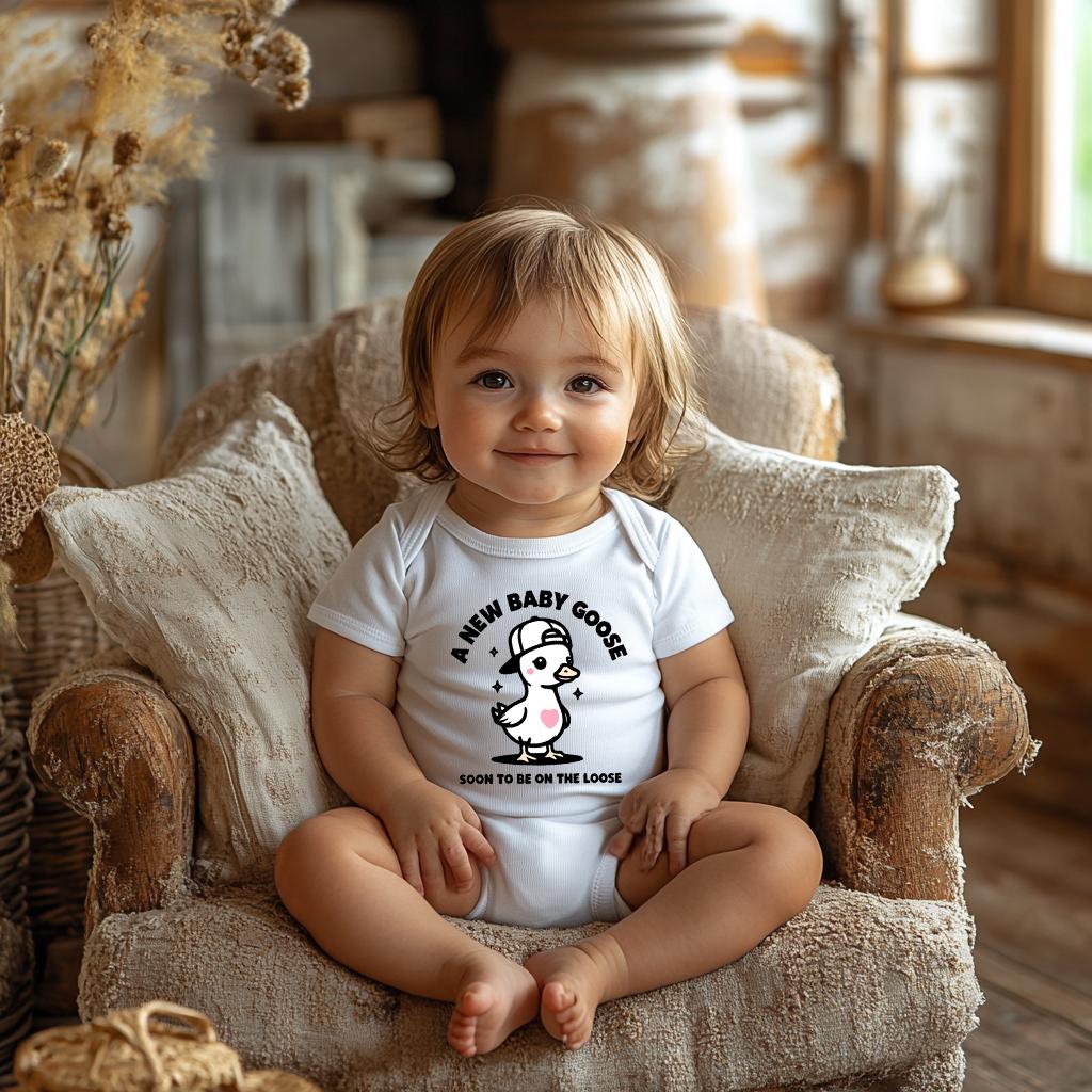 A New Baby Goose Soon to Be on the Loose! 🎉 Celebrate your exciting news with this adorable and funny baby announcement onesie. Perfect for pregnancy announcements, baby showers, gender reveals, or a sweet newborn gift. This charming bodysuit features a cute little goose wearing a stylish cap, adding a fun twist to your special moment!