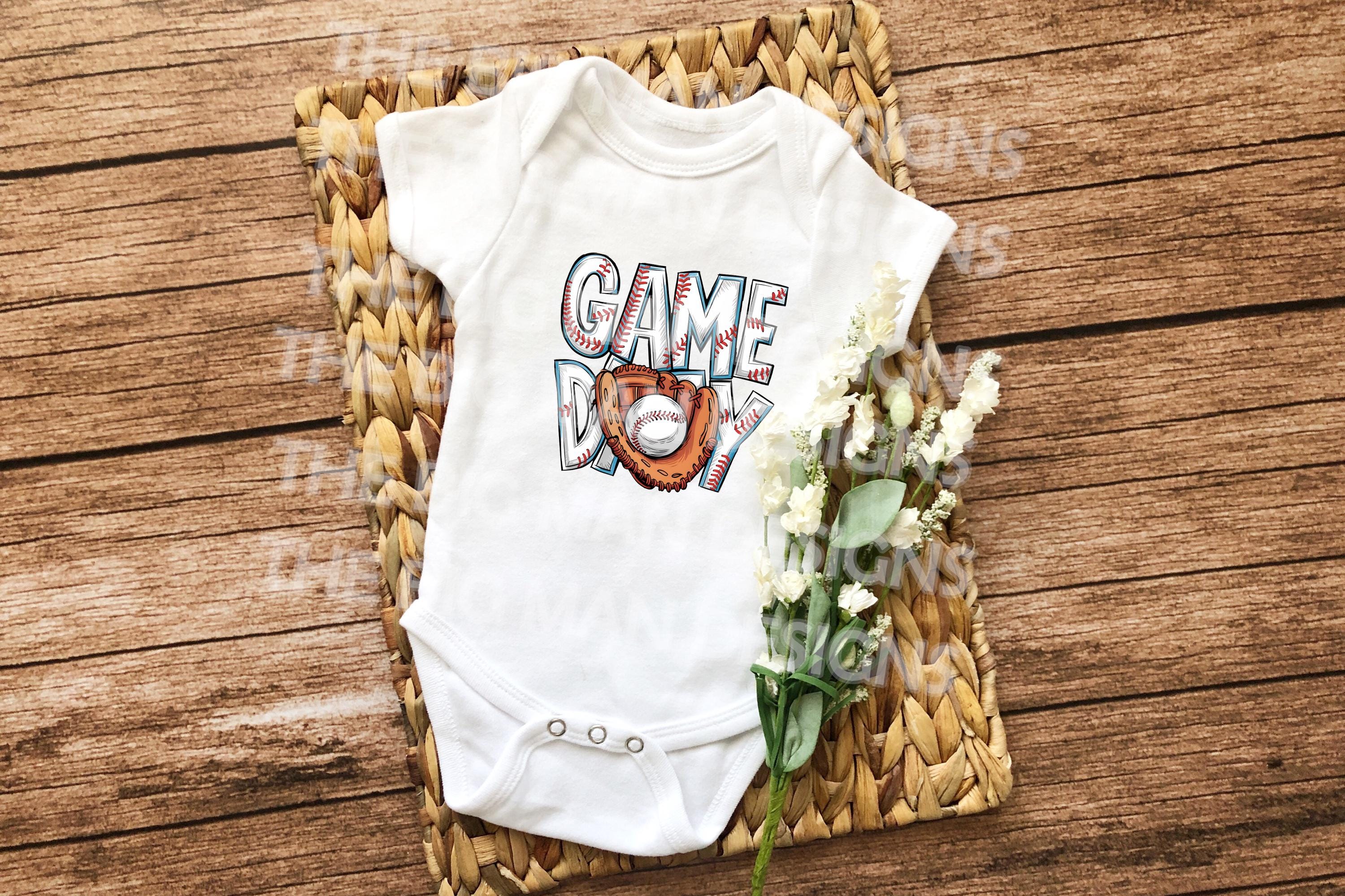 It's Game Day, and your little MVP is ready to cheer! ⚾🥎

Our "Game Day" design is available as either a cozy Gerber® baby onesie or a soft toddler T-shirt — perfect for family game days, sibling sports events, or baby's first trip to the ballpark.

Featuring a fun glove and baseball graphic, this outfit is a home run for any little fan in training! Ideal for photo ops, game day parties, or a cute and casual everyday look.