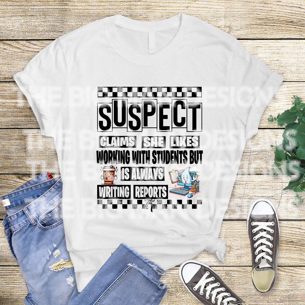 May include: A tan sweatshirt with black text that reads 'SUSPECT CLAIMS SHE LIKES WORKING WITH STUDENTS BUT IS ALWAYS WRITING REPORTS' with a checkered pattern above and below the text. The text is surrounded by a black border.