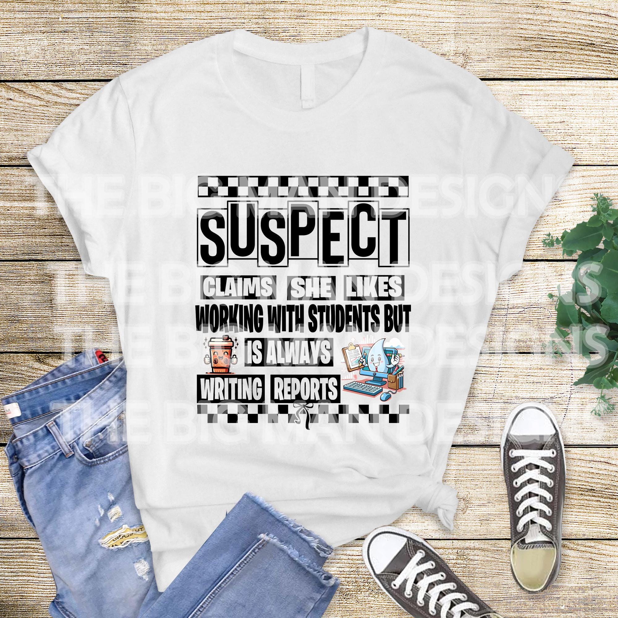 May include: A tan sweatshirt with black text that reads 'SUSPECT CLAIMS SHE LIKES WORKING WITH STUDENTS BUT IS ALWAYS WRITING REPORTS' with a checkered pattern above and below the text. The text is surrounded by a black border.