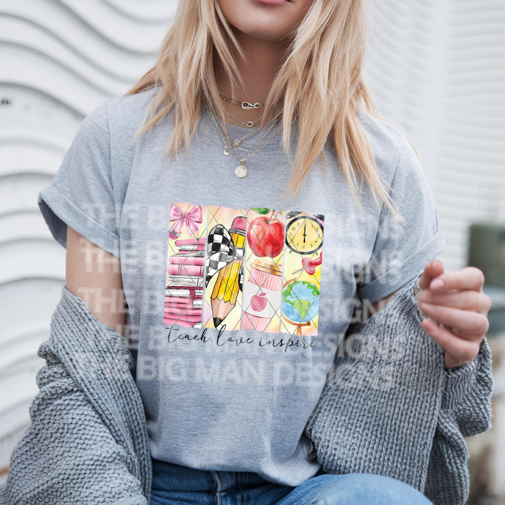 Woman wearing grey t-shirt with colorful school-themed "Teach Love Inspire" graphic.