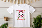 Toddler T-shirt with pink bow duck design styled with plants and rustic decor.