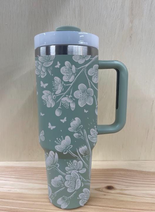 Floral Stanley-style tumbler with butterflies and blossoms lase engraved