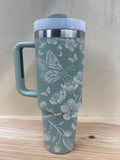 Laser engraved cherry blossom tumbler with white lid and handle, sage green color