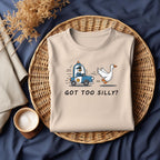 Natural folded T-shirt with Got Too Silly? DTF transfer (goose police chase design)