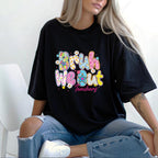 girl smiling wearing a black shirt with "Bruh We Out" and blue jeans. A great teacher gift for the end of the year or teacher appreciation.