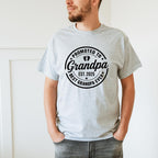 Matching shirts laid out side-by-side with "Promoted to Grandma" and "Promoted to Grandpa" designs