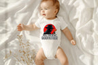Baby lying on soft white blanket wearing "Will You Be My Godfather" mafia style onesie.