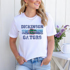 Smiling woman in white Gators shirt styled with jeans and flowers