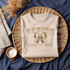 Make a stylish senior statement with this Senior Class of 2025 Leopard Bow DTF Transfer! Featuring a glam varsity font and trendy animal print bow, this ready-to-press transfer is perfect for t-shirts, sweatshirts, and graduation gifts for the girly grad.