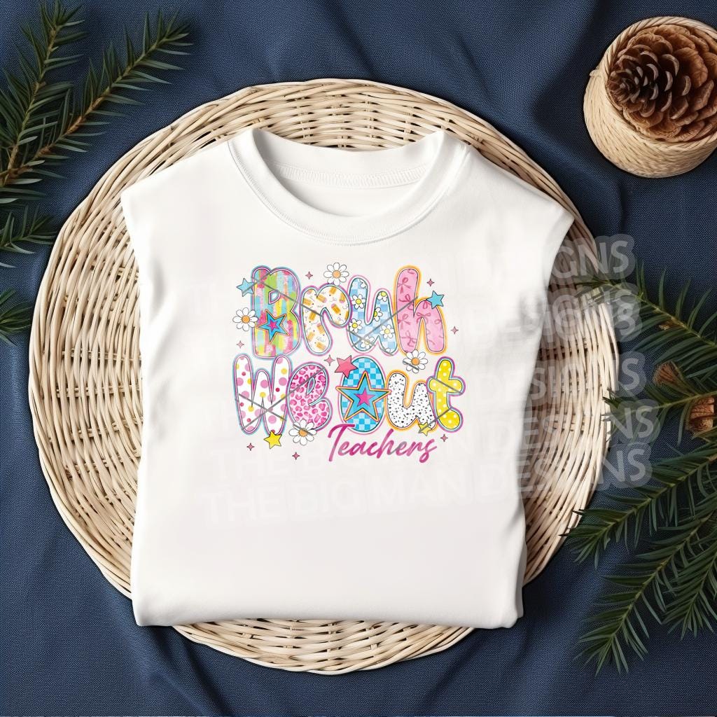 White t-shirt featuring “Bruh We Out Teachers” print folded neatly in a wicker basket with festive greenery decor.