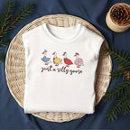 Flat lay of goose shirt design folded on wicker plate with navy cloth