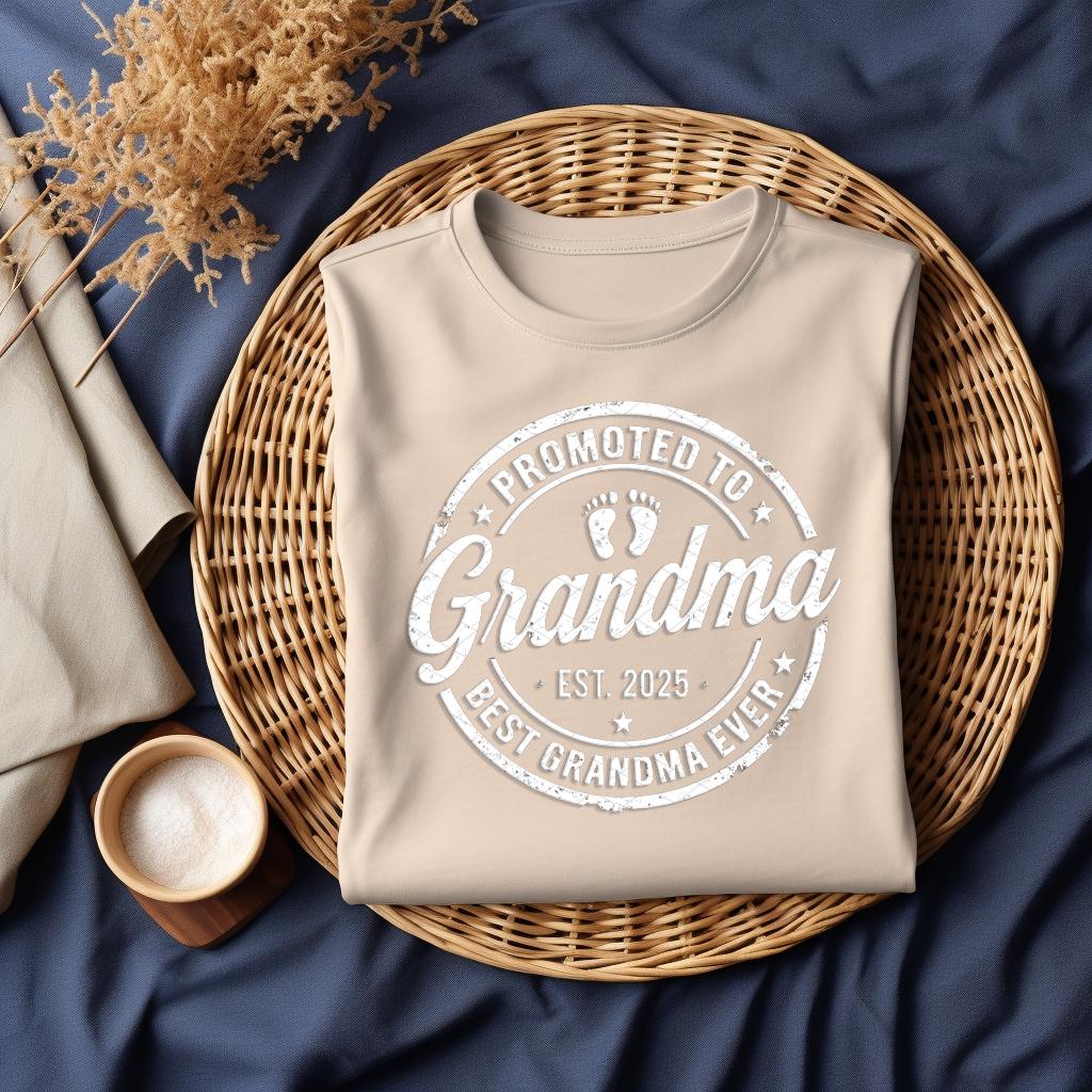 Beige shirt with "Promoted to Grandma, Est. 2025, Best Grandma Ever" design on woven basket.
